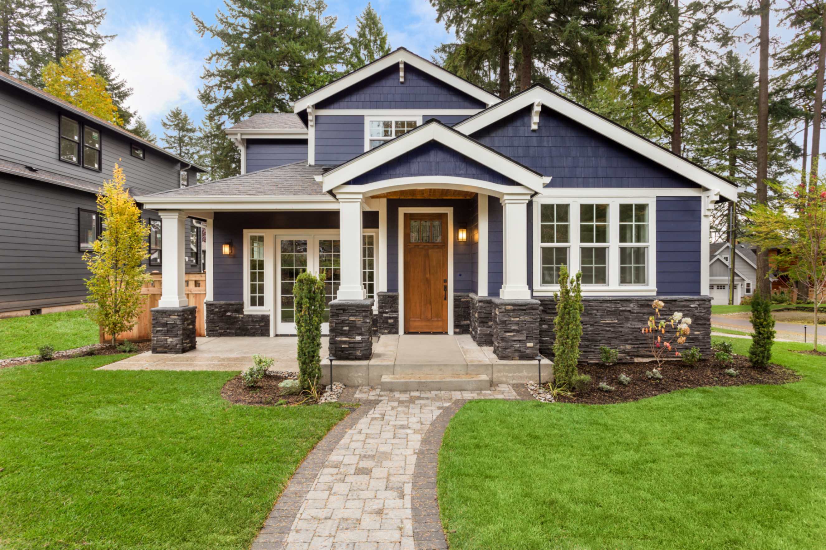 Blue house with garden and pathway.