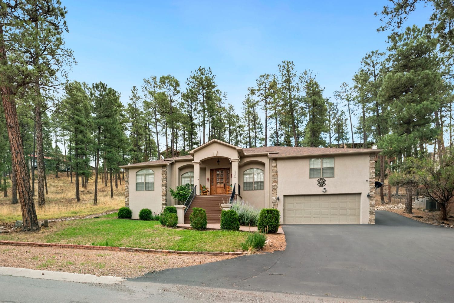 Single-story house with a welcoming entrance and attached garage.