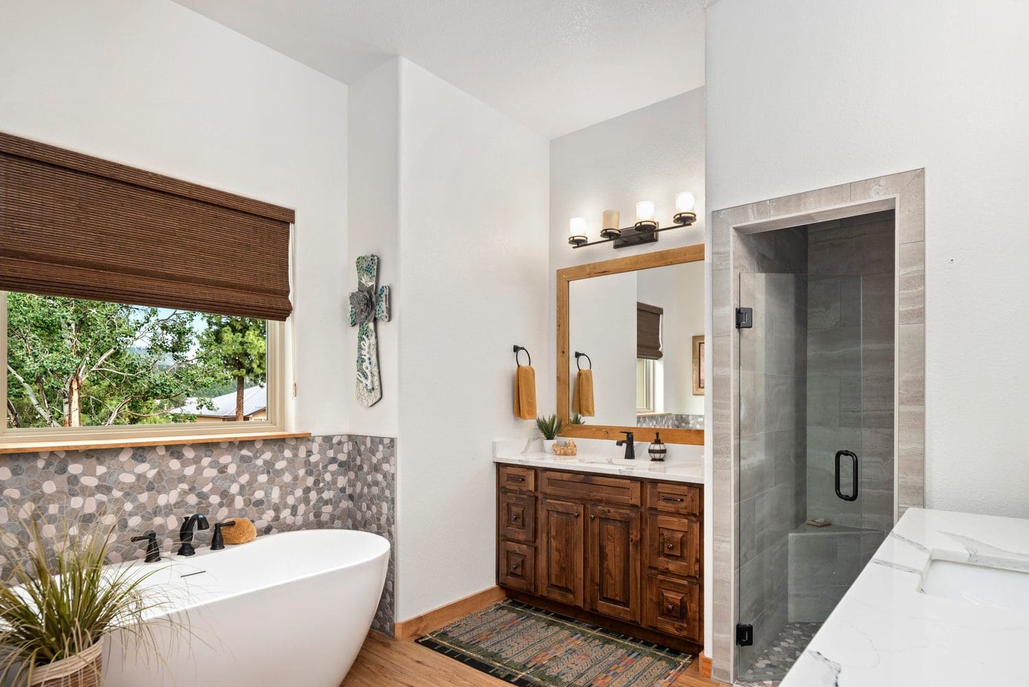 Elegant bathroom with a freestanding tub and wooden vanity.