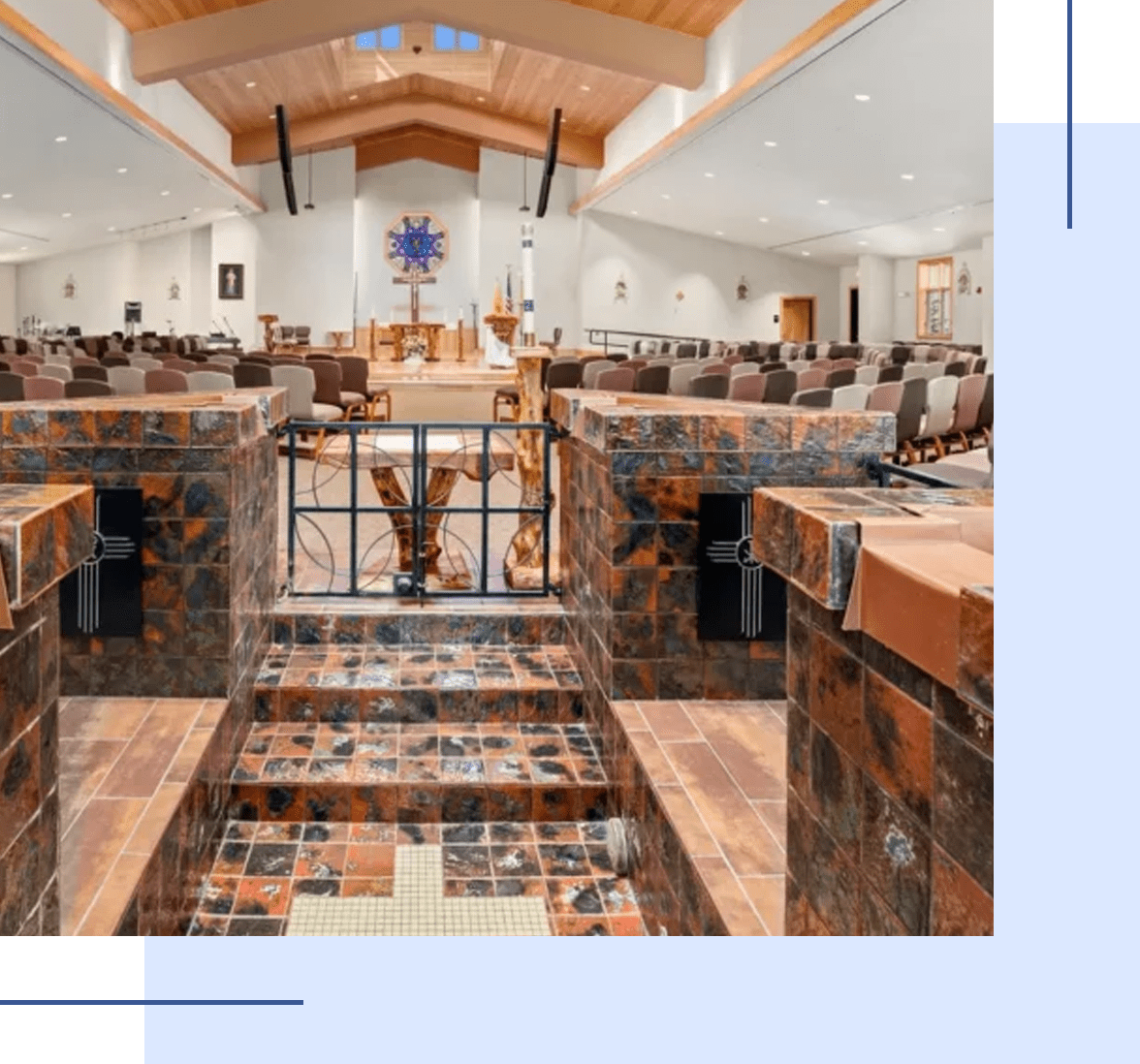Interior of a modern church with wooden pews and a tiled floor.