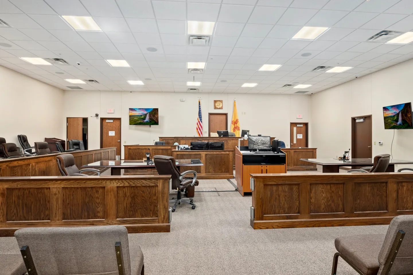 Empty courtroom with judge's bench and seating.