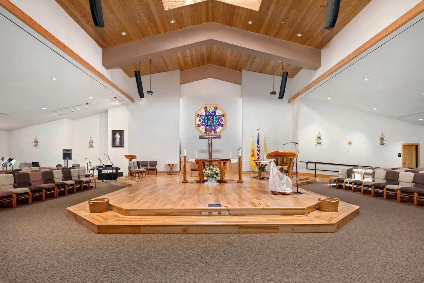 Interior of a modern church with wooden ceiling and altar.