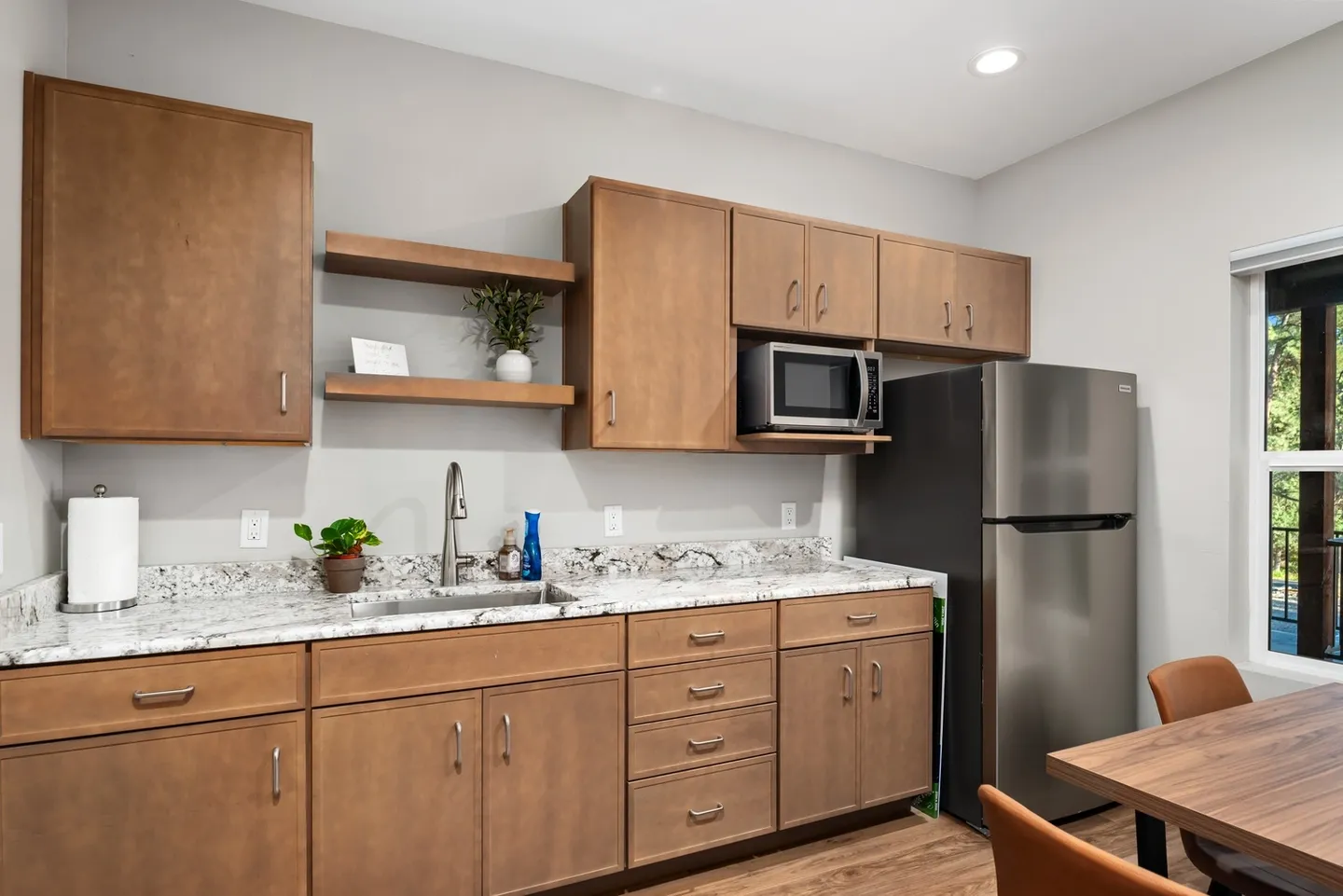 Modern kitchen with wooden cabinets and stainless steel appliances.