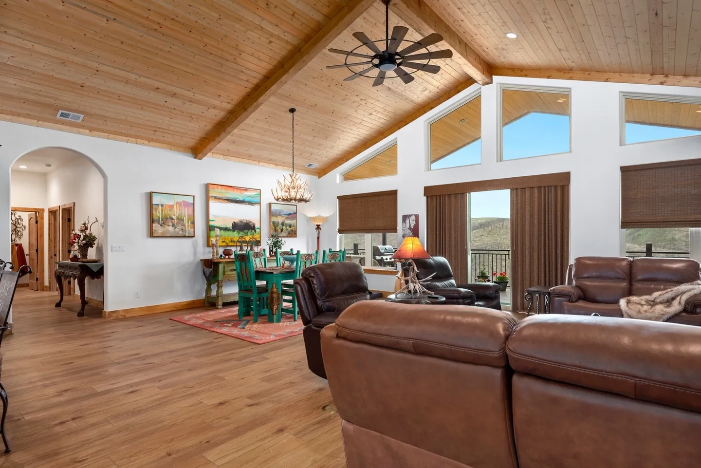 Spacious living room with vaulted wooden ceiling and cozy seating.
