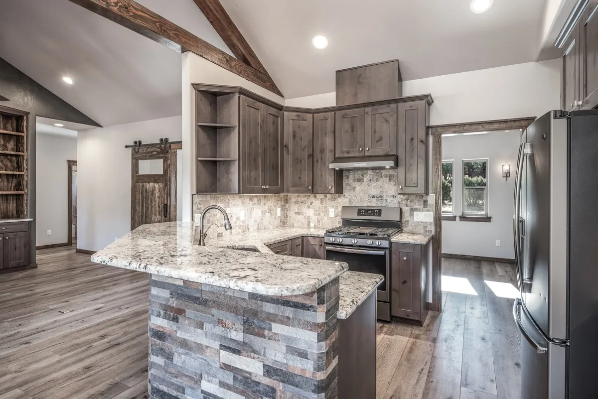 Modern kitchen with stone island and wooden cabinetry.