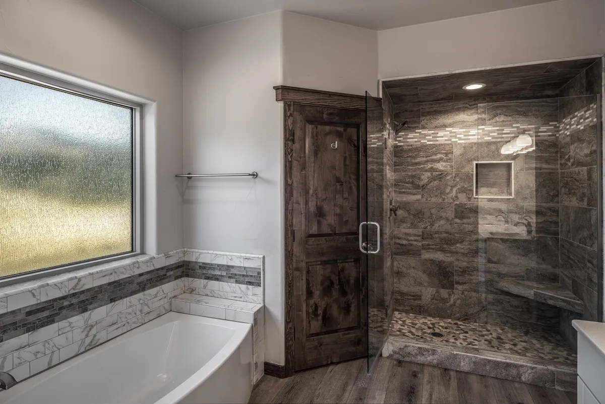 Modern bathroom with a tub and glass shower.